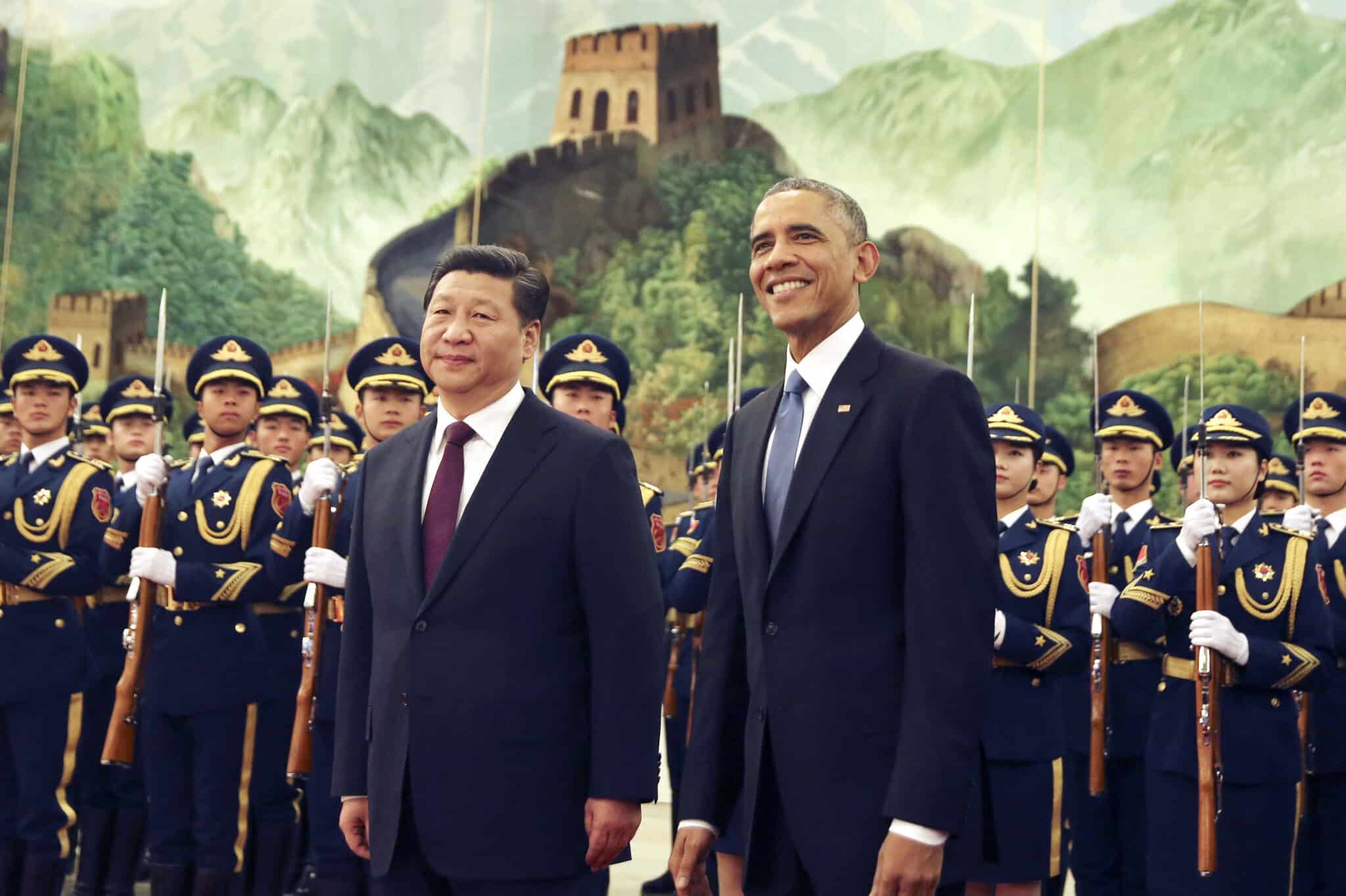 U.S. President Barack Obama, right, smiles after a group of children waved flags and flowers to cheer him during a welcome ceremony with Chinese President Xi Jinping at the Great Hall of the People in Beijing, China Wednesday, Nov. 12, 2014. When Xi Jinping took the reins of a booming China two years ago, President Barack Obama saw an opportunity to remake America's relationship with the Asian power. But even after Obama's unusually robust efforts to forge personal ties with Xi, the two leaders are meeting in Beijing amid significant tensions, both old and new. (AP Photo/Andy Wong)